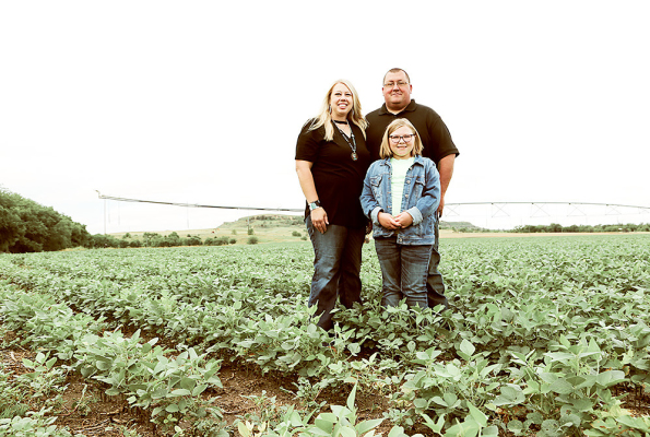 JESSE AND ANNA LUNA, pictured with their daughter, Olivia, are one of Kansas Farm Bureau’s 2022 Farm Families of the Year. The Lunas are pictured here at their farm in Ellis County. The Lunas received their award at Kansas Farm Bureau’s annual meeting held December 3-5.