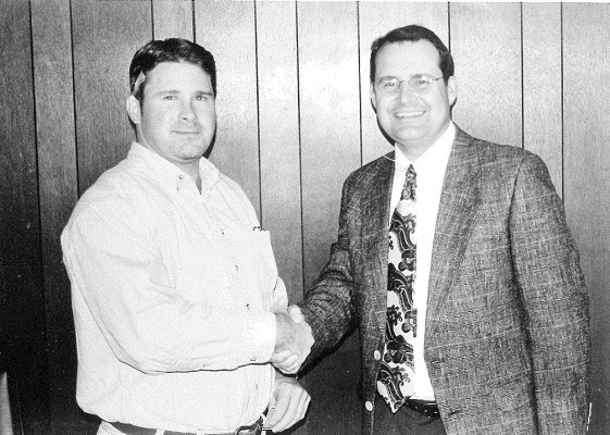 SCOTT NOVOTNY (left) was congratulated by Stockton Area Chamber of Commerce President Chris Kollman for being selected as the 1997 November Volunteer of the Month.