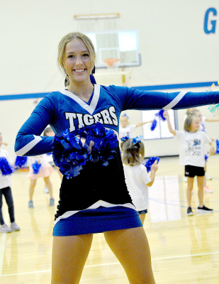 CLAIRE PLUMER leads the young cheerleaders in a routine during the Tiger Back-To-School Bash held on August 19.