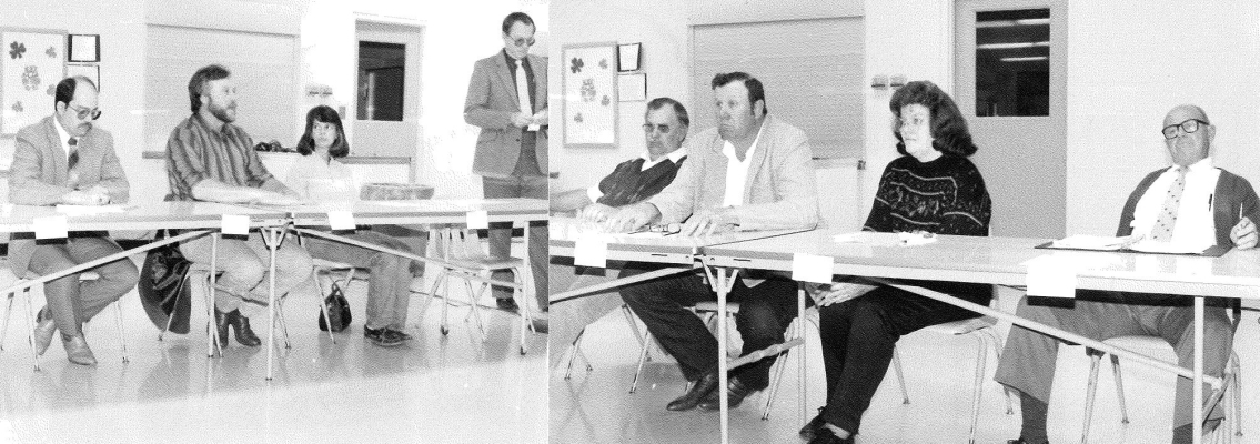 LOREN GOODHEART (standing in the center) was the Master of Ceremonies at the Public Forum for the candidate question and answer session held in March of 1991. Pictured are (from left): Scott Ross (BOE member), Jim Stice (BOE), Becky Lewis (BOE), Leo Kollman, Don McLaughlin (BOE), Venita Cole (BOE) and Elton Smith (city commission).