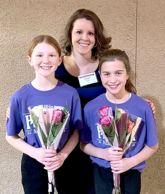 STOCKTON GRADE SCHOOL STUDENTS Omree Dibble and Harper Lowry participated in the KMEA All-State Honor Choir in Wichita on Thursday, February 23rd. Family and friends attended the performance. Pictured are Omree Dibble, music teacher Megan Riener, and Harper Lowry.