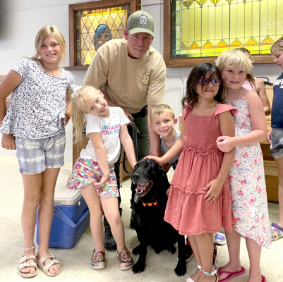 JOINING GAME WARDEN Jake Brooke and Kreed for a picture at the Stockton Church of Restoration were (from left) Maggie Butler, Kitlynn Snyder, Jake Brooke, Kreed, Lincoln Perez, Hallie Gallaway, Malie Jones, and Shoni Jones.