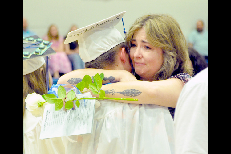 SHS GRADUATE Noah Ferguson receives a hug after giving his mother, Erika Thornburg a rose at Commencement.