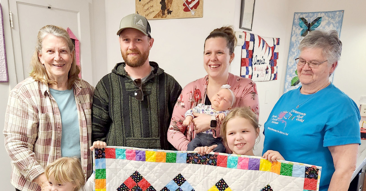 THE CROSSROADS QUILT GUILD presented the 2024 New Year’s Baby with a beautiful quilt. Sweet baby Rebekah VanSkike, her parents Luke and Holly, and big sisters Katie and McKenzie attended the March guild meeting to receive the colorful quilt, which was lovingly made by members Betty Bedore and Elaine Hrabe.